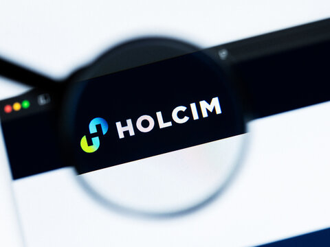 Milan, Italy 2026, 20 Apr Closeup of Holcim website on a laptop screen. Holcim logo under a magnifying glass.
