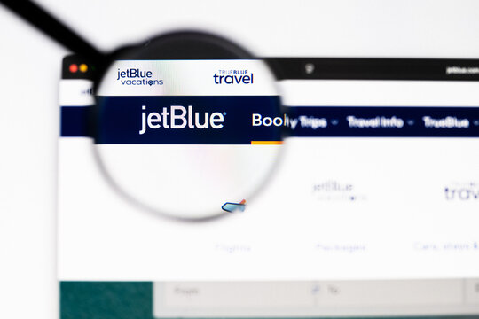 Milan, Italy 2026, 20 Apr Closeup of jetblue website on a laptop screen. jetblue logo under a magnifying glass.