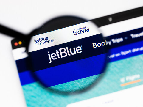 Milan, Italy 2026, 20 Apr Closeup of jetblue website on a laptop screen. jetblue logo under a magnifying glass.