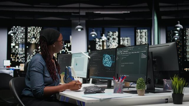 Programmer taking notes at desk in Silicon Valley company office, developing apps. IT expert using machine learning to do coding, writing on notepad, debugging applications to resolve issues.