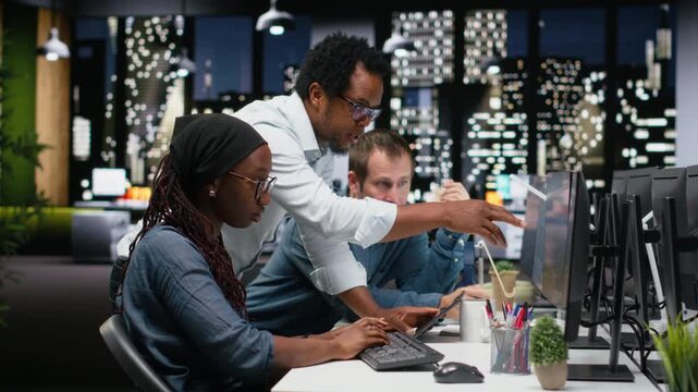 Technicians using PC in office, working with AI programming languages. Coworkers using computer in company workplace to do artificial intelligence tech quality assurance for coding workflows.