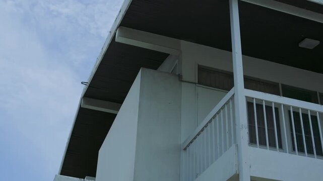 Vintage Thai Style House Exterior with White Balcony