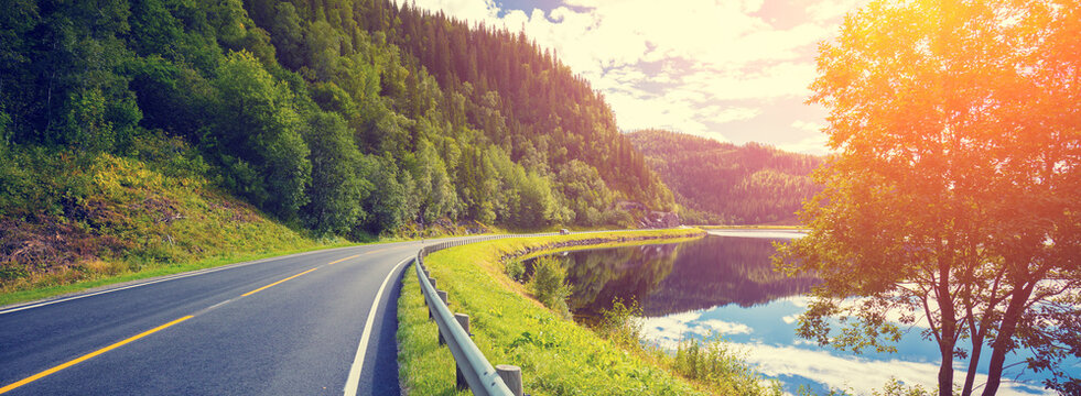 Driving a car on a mountain road along the fjord. Nature Norway