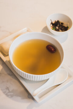 double boled chicken soup cantonese style with chinese mantou and picked vegetables on the side