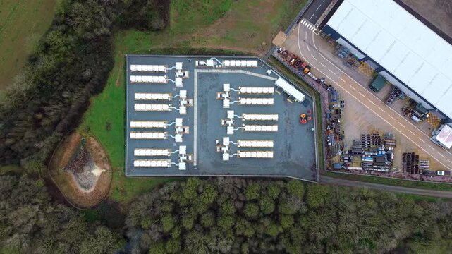 High angle perspective of an electrical utility yard and mega battery storage bank for renewable power England