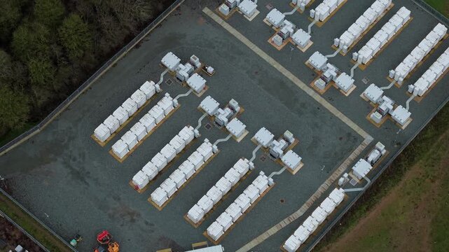 High angle aerial drone view of a large battery energy storage system BESS at an electrical grid substation in the United Kingdom