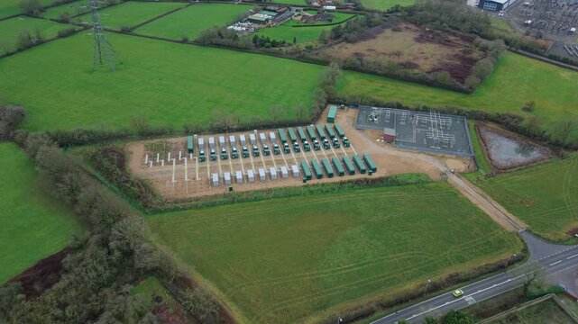 Top down drone view of industrial battery containers for renewable energy storage at a power grid hub England