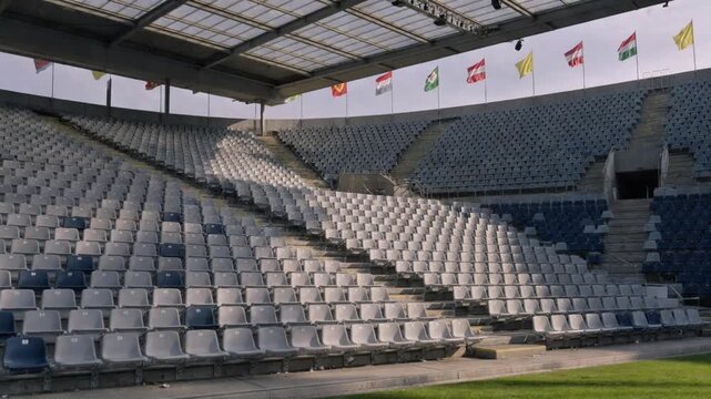 Wide Angle View of Empty Seating in a Modern Sports Stadium with National Flags