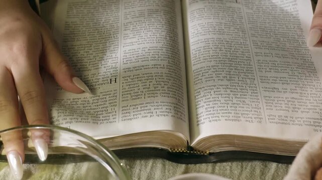 young conservative asian Woman Reading the Bible at table with bread food and drink indoors