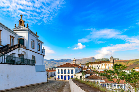 A cobblestone street leads into the historic city of Ouro Preto.