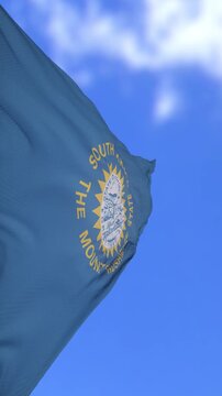 South Dakota State Flag Waving Against Bright Blue Sky