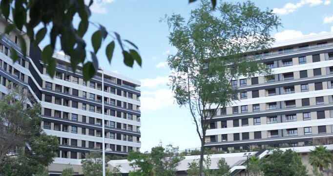 Three frames show modern apartment buildings surrounded by trees