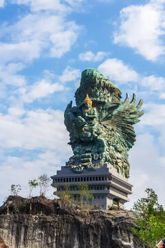 Bali, Indonesia - Sep 23, 2018: The Garuda Wisnu Kencana statue rises above a limestone cliff at GWK Cultural Park in Ungasan, depicting the Hindu god Vishnu riding the mythical Garuda bird.