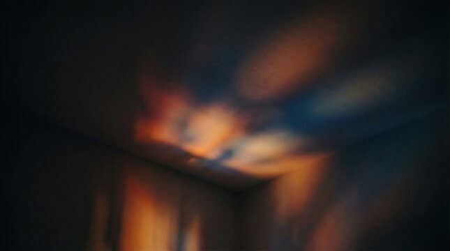 Abstract colorful light projection on a dark room ceiling creating a dreamy nebula effect.