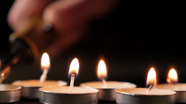 Lighting candles for a special occasion with focus on flame and hand