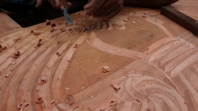 Master wood carver creating intricate handcrafted ornaments