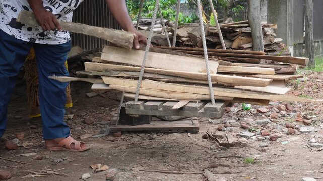 Firewood weighed for sale on traditional balance scale