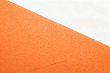 Fototapeta premium Close-up of Orange Paper Texture with Cracks
