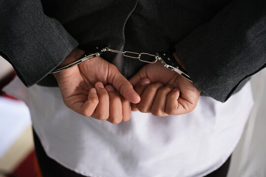 Handcuffed behind his back. Concept of Arrest and Crime, World Justice Day
