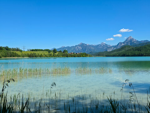 germany, pristine weissensee beach with majestic alpine backdrop and crystal clear waters inviting summer relaxation