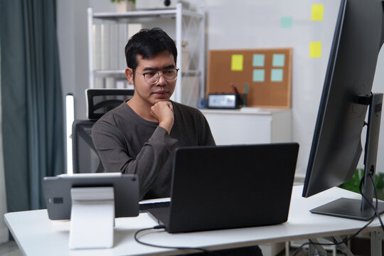 Focused Developer Engaged in Coding and Problem-Solving at a Workspace
