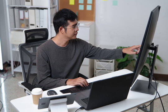 Focused Developer Working on a Computer in a Professional Office Environment