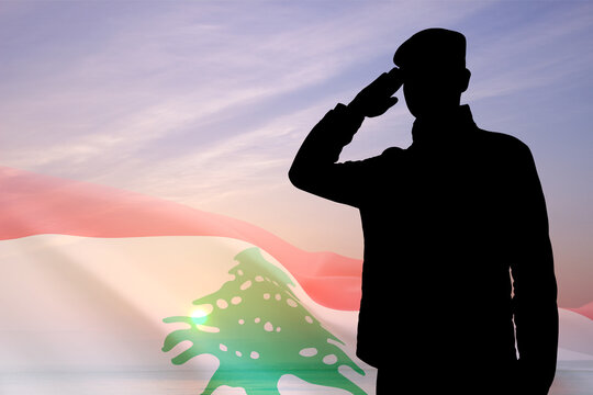 Silhouette of a soldier with Lebanon flag against the sunset. National Holidays concept. Armed Force of Lebanon