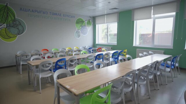 Empty educational lunchroom stands completely ready for students meal breaks. Well-organized space emphasize clean welcoming environment