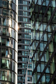 Glass facade detail in Frankfurt Bankenviertel, Germany, shows an office tower in reflection, where urban architecture layers steel and curved windows