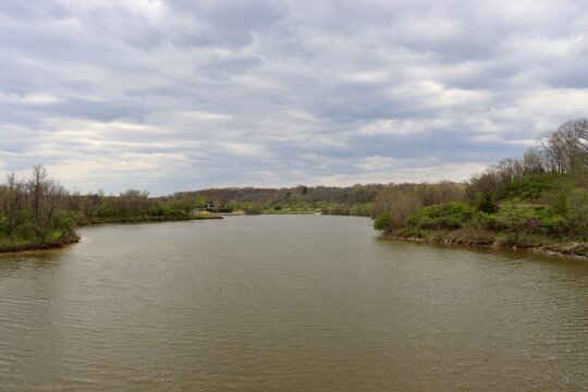 The peaceful lake in the country on a cloudy day.