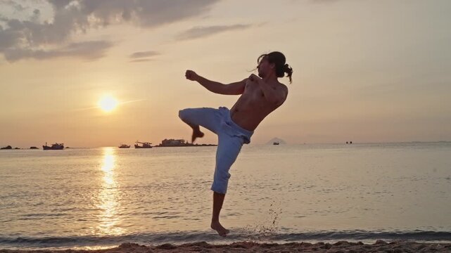 A martial artist trains on the beach at sunrise, throwing a kick and a tornado kick. A lone person near the shoreline on a sandy beach at sunset, with calm water, low sun reflections