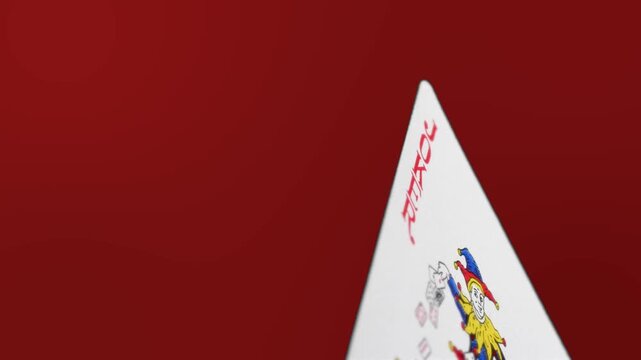 Joker Playing Card on Red Background Minimal Gambling Concept