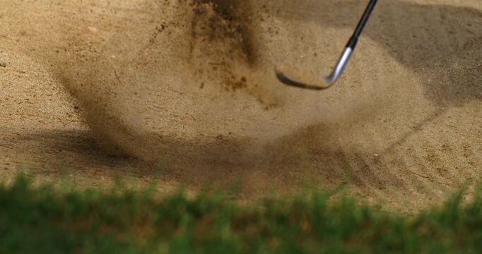 Super Slow Motion Of Golf Bunker Shot With Sand Explosion. Concept Of Precision Under Pressure. Dramatic slow motion footage of a golfer escaping the bunker as sand bursts into the air.