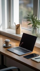 Fototapeta premium Minimalist workspace setup featuring a laptop smartphone coffee mug and natural light for modern productivity
