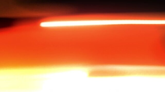light wife transition streak energetic glow motion blur orange bright zoom effect. This video is ideal for creating dynamic transitions or highlighting movement and energy.