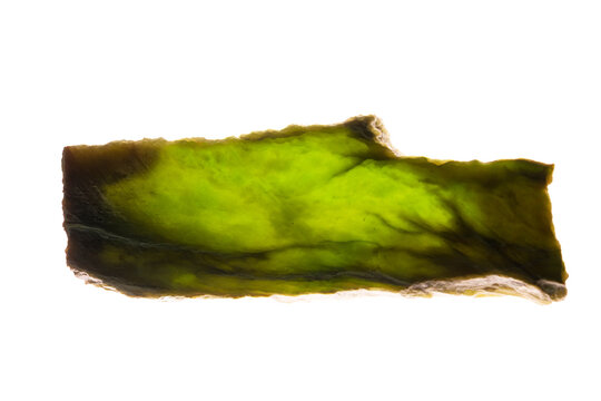 Nephrite jade gemstone on white background; closeup image of natural mineral stone