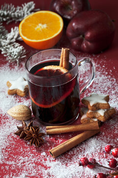 Glass of mulled wine with slice of orange and cinnamon stick