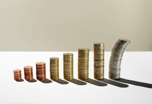 Tumbling euro coin stack representing financial crisis and risk