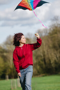 Flying a colorful kite in a city park on a windy spring day