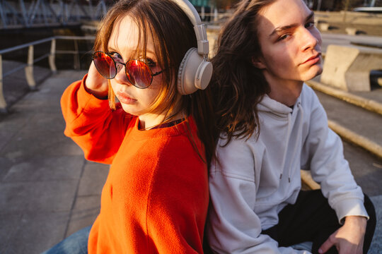 Youth with headphone and eyewear showing serious attitude outdoors