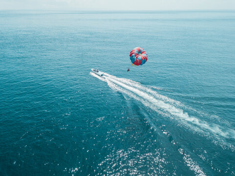 Nusa Dua, Bali, Nusa Dua, Aerial view of person parasailing and motorboat