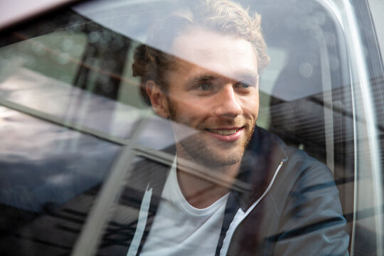 Young man getting out of the car