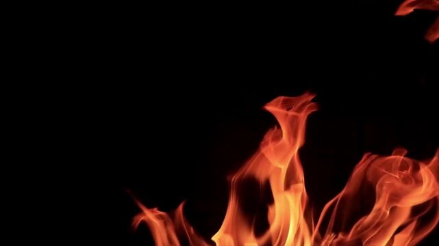 Close up realistic fire flames on black background, blazing heat and burning energy animation, cinematic flame effect, dramatic 4k motion graphics