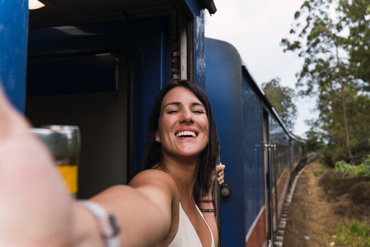 Woman taking a selfie on a moving train in Ella Sri Lanka