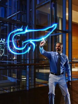 Mature male doctor light painting pancreas in laboratory at hospital