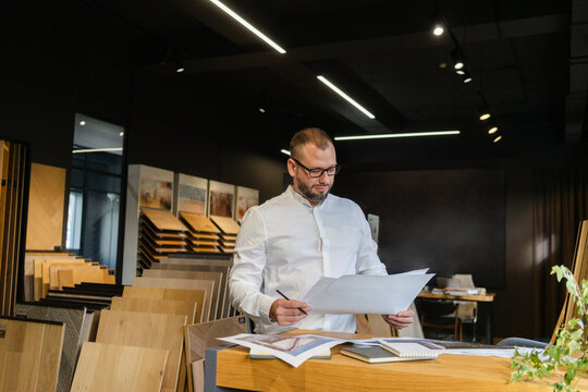 Businessman looking at plan in architect's office