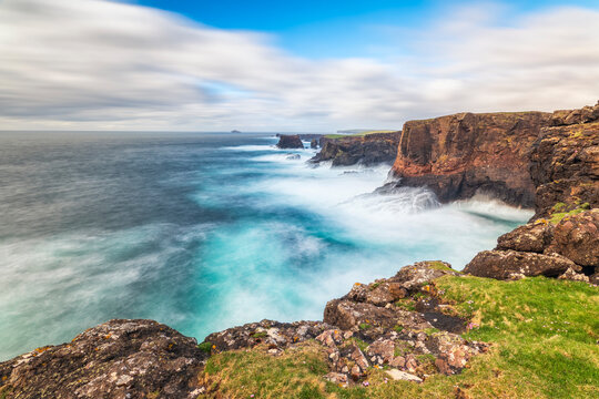 UK, Scotland, Long exposure of waves splashing against cliffs of Esha Ness