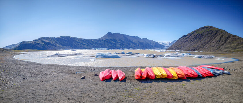Colorful kayaks at Heinabergslon glacier lagoon in Iceland