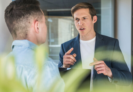 Angry businessman arguing with colleague in office