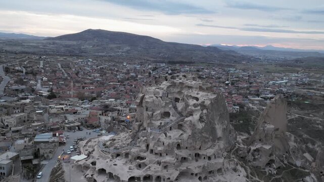 Drone view of Ortahisar Castle towering above the historic town of Ortahisar in Cappadocia, Turkey. A remarkable example of rock-carved architecture.